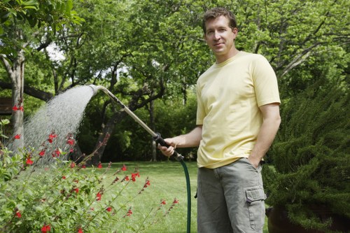 Gardener pruning shrubs in Anerley